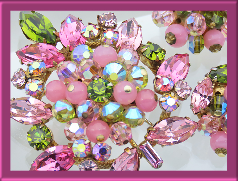 A Regency feminine pastel brooch of rhinestones and pink dangling beads.